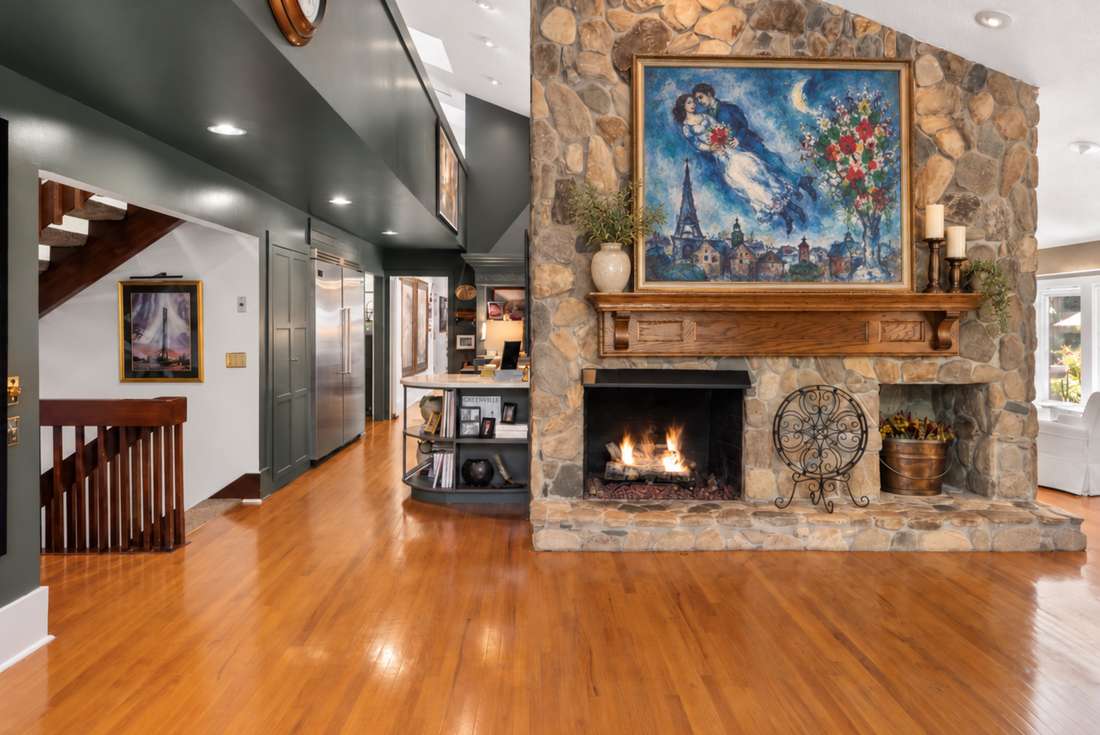 Family room beneath the two-story fieldstone chimney